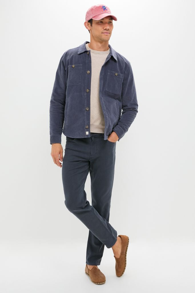Model in classic Navy Stretch Terry 5 Pocket pants, showcasing an effortless, high-end style with a chore-style jacket and loafers, embodying fun and adventure-ready fashion.