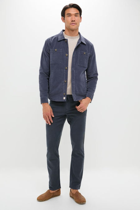 Model in classic Navy Stretch Terry 5 Pocket chinos, styled with an effortless navy chore jacket and suede loafers, exuding a high-end, fun, smart-casual vibe.