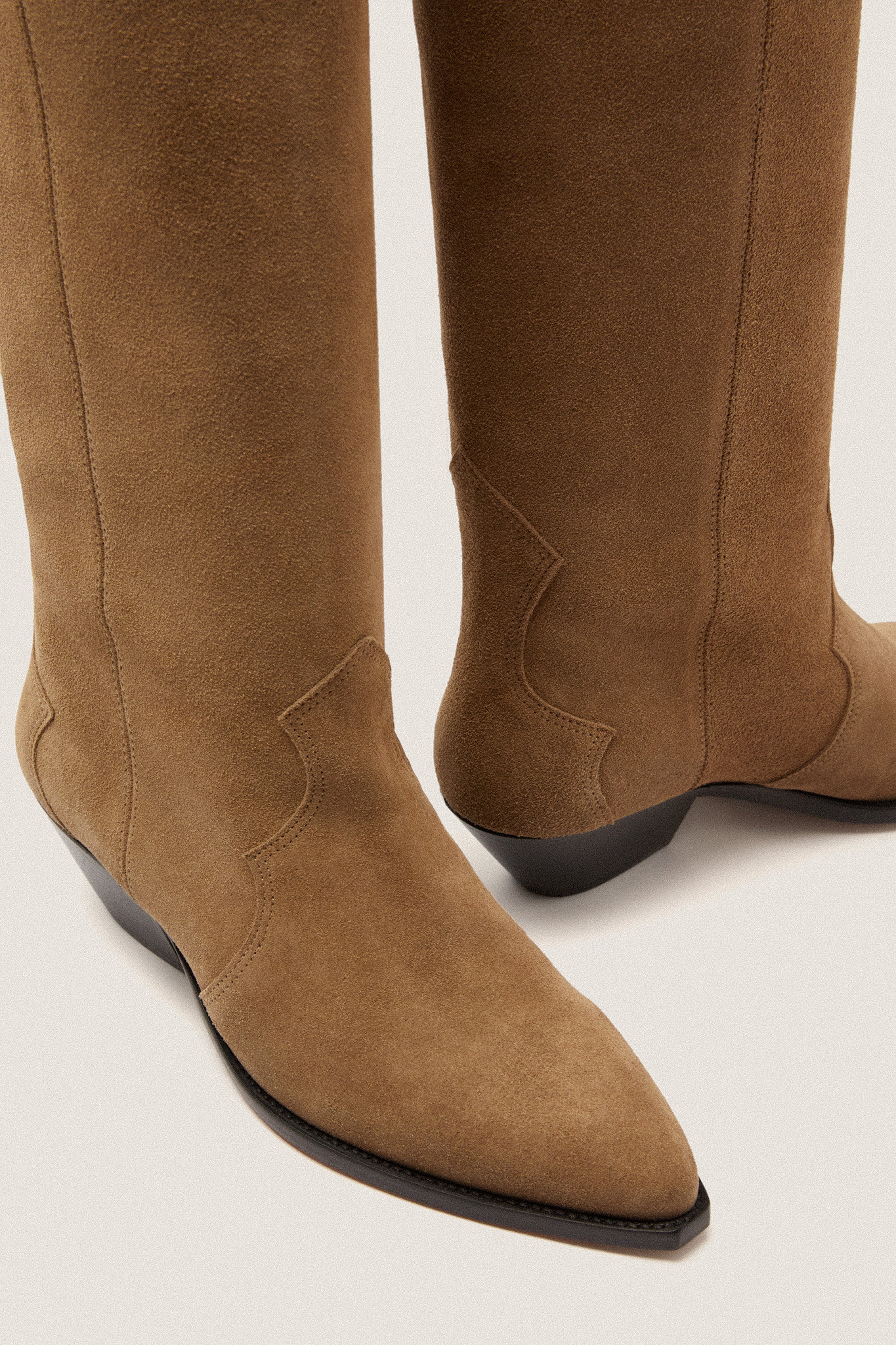 Taupe Denvee Boot, classic suede western-style with pointed toes, low heels, and intricate stitching, embodying effortless high-end style for fun, versatile outfits.