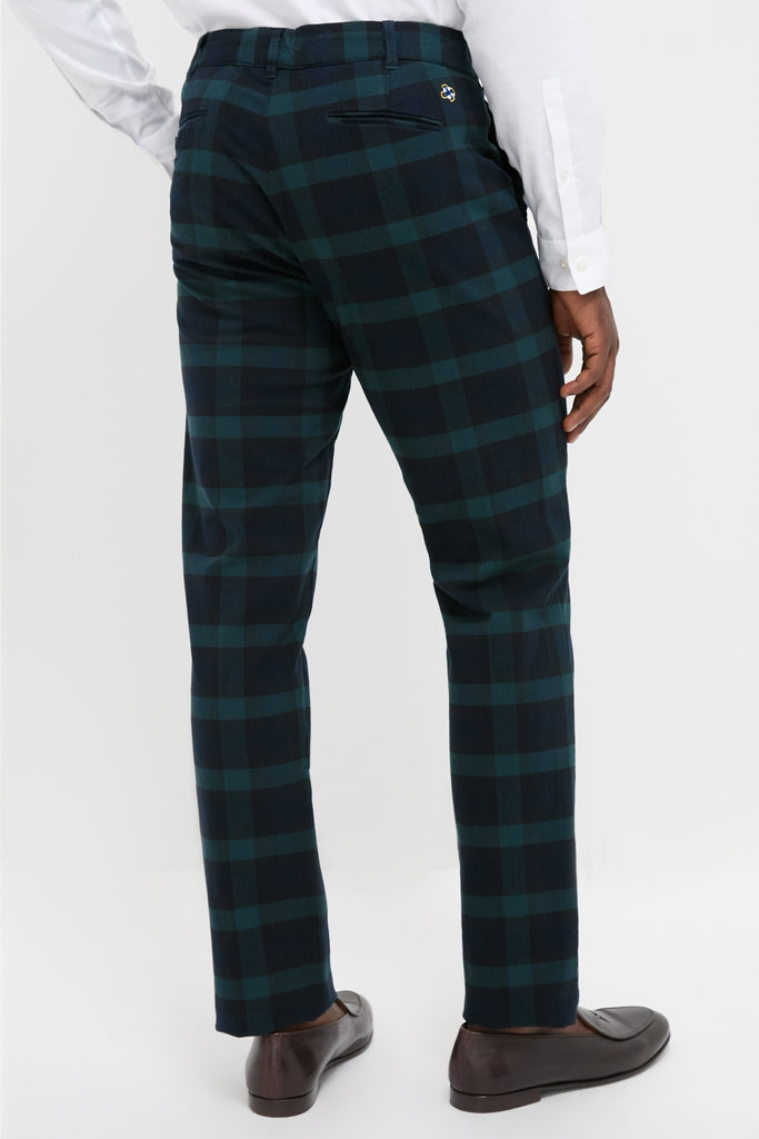 Man wearing Blackwatch Tartan Stretch Twill Harbor Pants (34 Inseam), showcasing a classic, effortless fit with a fun check pattern, paired with a white shirt and leather loafers.