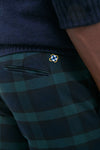 Profile view of classic Blackwatch Tartan Stretch Twill Harbor Pants with a small embroidered emblem, offering an effortless, high-end look ideal for fun, stylish occasions.