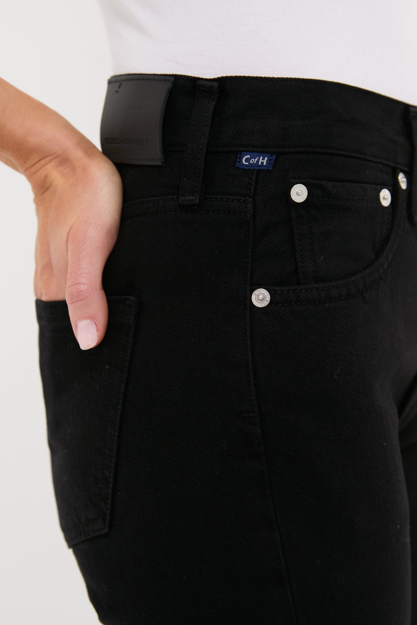 Solid Black Blaine Jean: classic high-rise, straight-leg denim with silver rivets, leather patch, and fabric label, embodying effortless, high-end style with a fun, vintage-inspired fit.