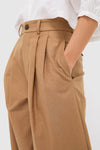 Classic Umber Slubby Cotton Atelier Pleated Pant 2 with wide-leg and double pleats, paired with a white blouse for an effortless, high-end look.