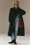 Woman models the classic Navy Wool Trinity Coat, effortlessly styled with straight-leg jeans and suede ankle boots, showcasing high-end, fun, and modern elegance.