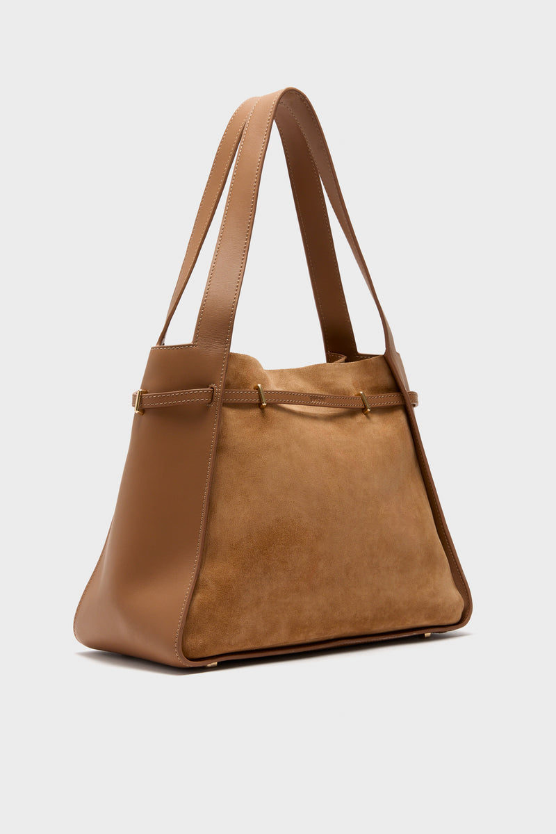 Classic Camel Cleo Suede Tote with a sculptural silhouette, combining smooth leather and matte suede. Effortlessly high-end, featuring gold-tone hardware and a fun, versatile design.