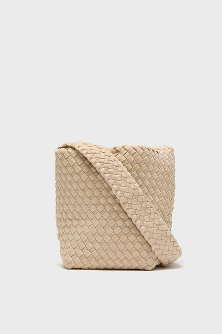 A beige handwoven neoprene crossbody bag with a wide strap from Naghedi is featured.