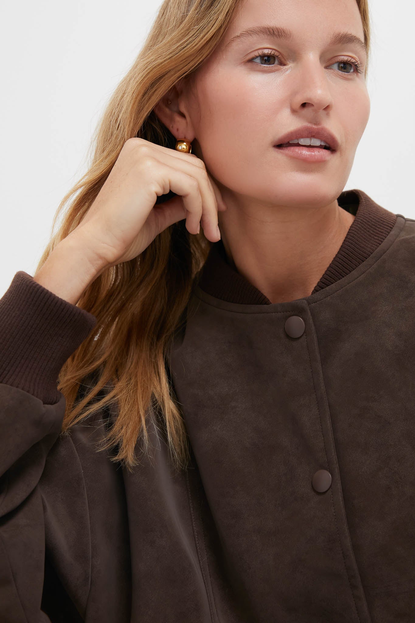 Woman wearing the Chocolate Alfie Jacket, a classic, high-end bomber style with a modern twist, featuring ribbed trims and a snap placket for effortless, fun fashion.
