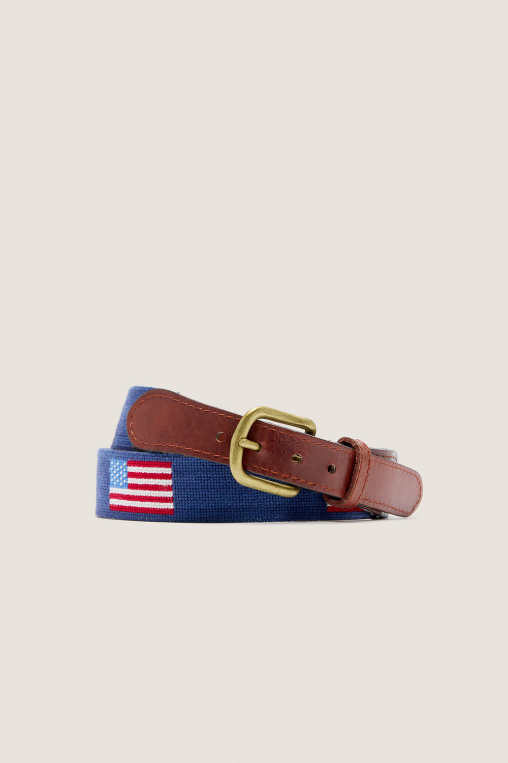 American Flag Needlepoint Belt: Classic navy-blue webbing with embroidered flag, finished in brown leather, brass buckle, exudes effortless style and high-end craftsmanship.