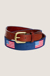 American Flag Needlepoint Belt with classic U.S. flag motifs on blue needlepoint fabric, brown leather trim, and brass buckle, offering an effortless and fun high-end style.