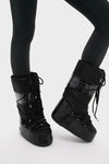 Black Icon Glance Boots, effortlessly classic and fun, feature a high-end, glossy design with lace-up details and a padded upper, ideal for adventurous style.