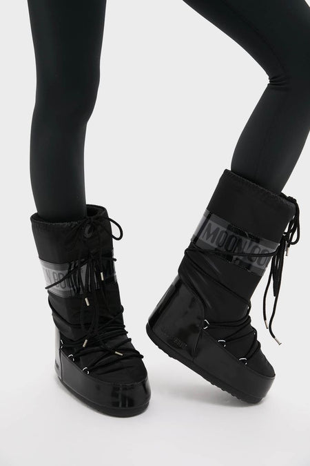 Black Icon Glance Boots, effortlessly classic and fun, feature a high-end, glossy design with lace-up details and a padded upper, ideal for adventurous style.