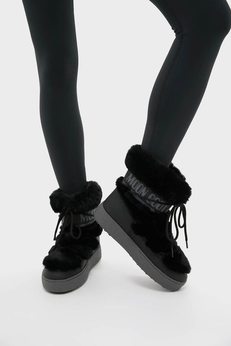Black LTrack Faux Fur Boots with plush fur cuffs and criss-cross laces, offering classic, effortless style and high-end comfort for fun winter adventures.