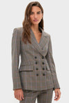 Woman models the Russet Multi Claude Dickey Jacket, a classic check-patterned, double-breasted blazer with matching slim-leg trousers, embodying effortless, high-end business-casual style.