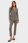 Model wearing the Russet Multi Claude Dickey Jacket, a classic double-breasted houndstooth suit with slim-leg trousers, exuding an effortless, high-end, and fun style.