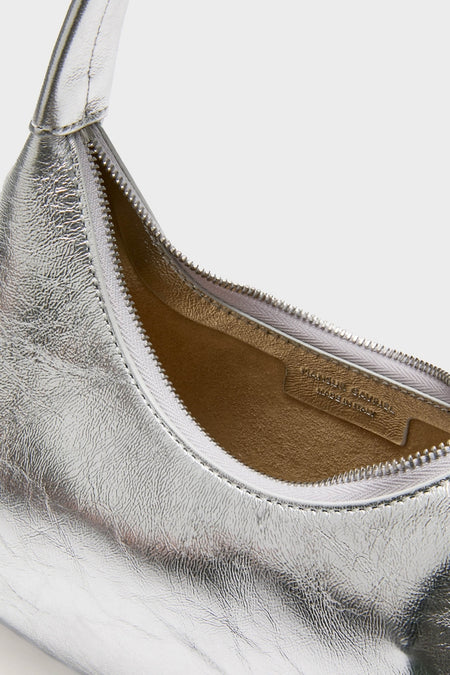 Silver Mini Candy Bag: a classic, high-end metallic-silver hobo handbag with a circular strap and zip closure, showcasing an effortless, fun tan suede-like interior.