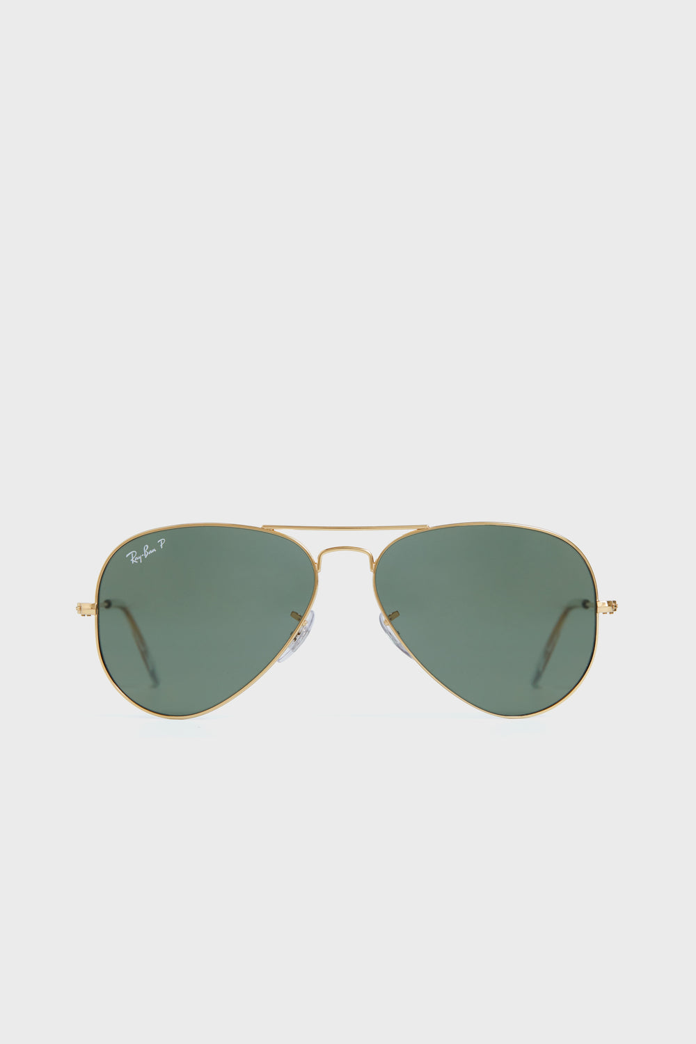 Ray-Ban Aviator sunglasses featuring gold metal frames and green polarized lenses are displayed.