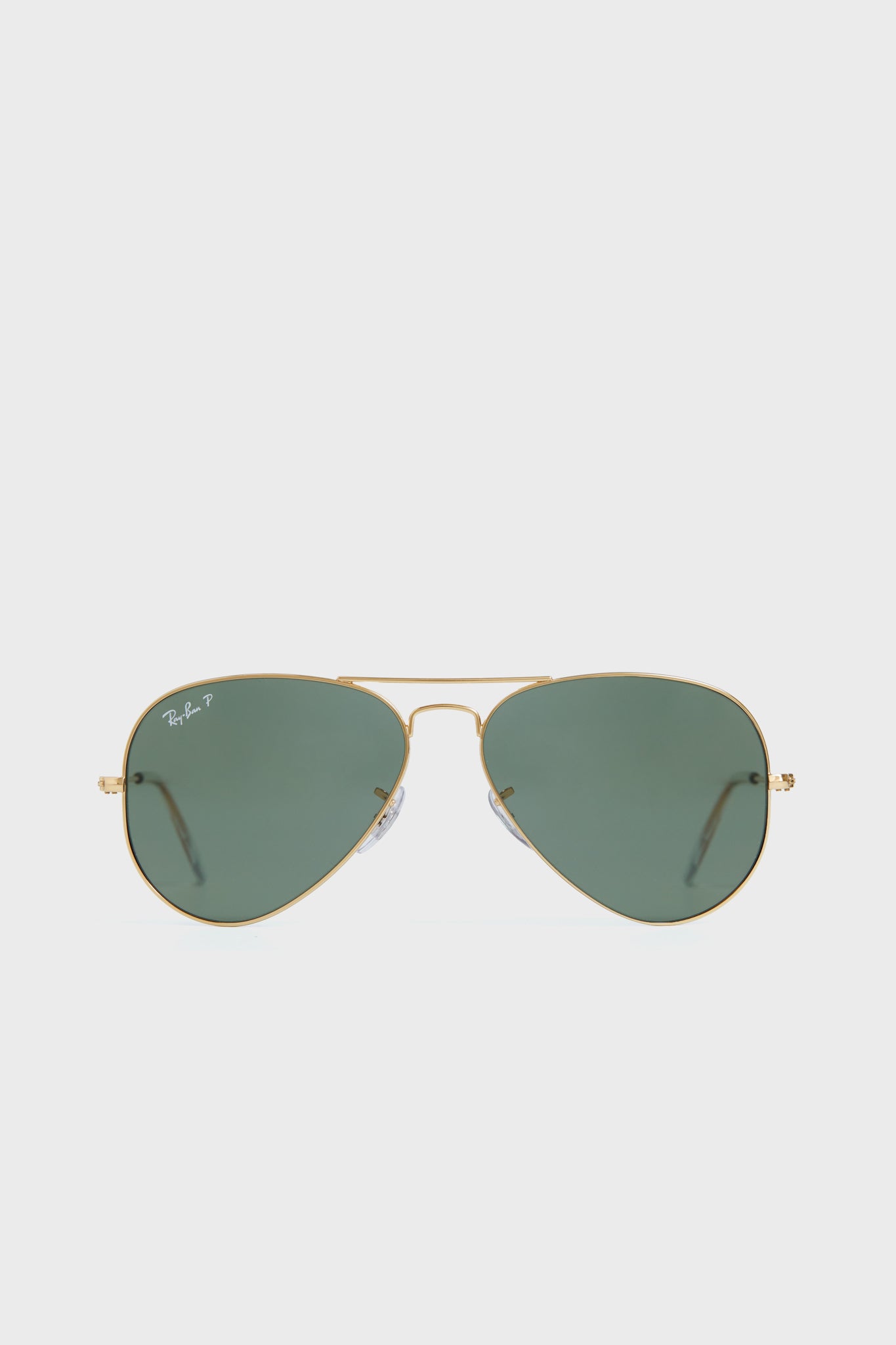 Ray-Ban Aviator sunglasses featuring gold metal frames and green polarized lenses are displayed.