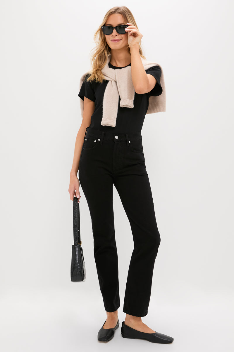 Woman in Solid Black Blaine Jean, high-rise and vintage-inspired, with effortless style; paired with black top and accessories, exuding classic, fun, high-end elegance.