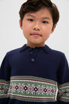 Child wearing the Fairisle Collar Sweater, a classic navy knit with a Fair Isle design. Effortless style for fun occasions, reflecting Tuckernuck's high-end, cool vibe.