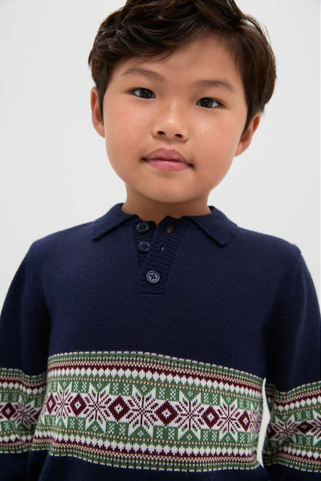 Child wearing the Fairisle Collar Sweater, a classic navy knit with a Fair Isle design. Effortless style for fun occasions, reflecting Tuckernuck's high-end, cool vibe.