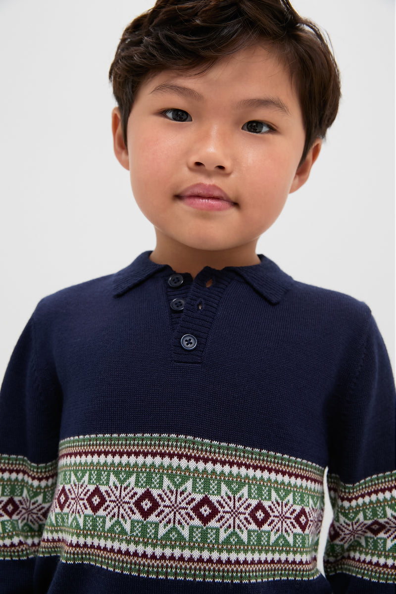 Child wearing the Fairisle Collar Sweater, a classic navy knit with a Fair Isle design. Effortless style for fun occasions, reflecting Tuckernuck's high-end, cool vibe.