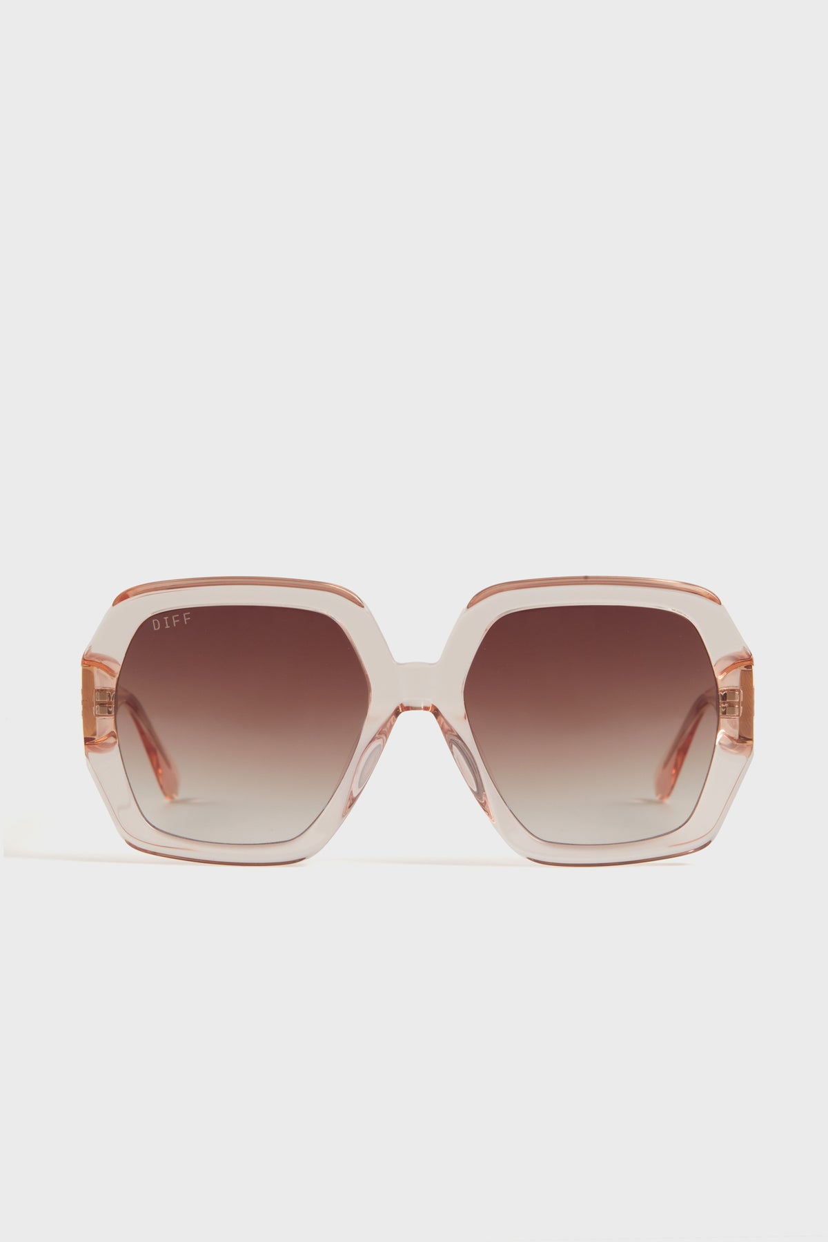 Oversized square sunglasses by DIFF Eyewear featuring light pink translucent frames and brown ombre lenses.