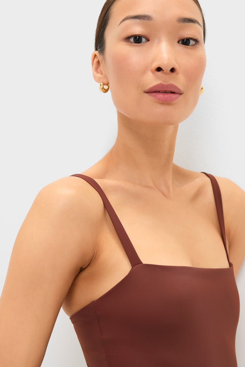 Woman wearing the classic Cappuccino Isabel One Piece, a high-end, sleeveless top with thin straps, exuding effortless style and fun elegance.