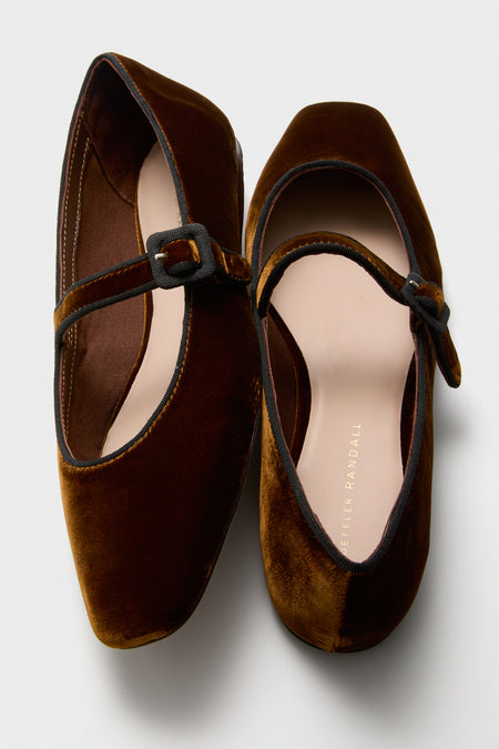 Loeffler Randall brown velvet flats with black trim, buckles, and an adjustable arch strap are shown on a white background.