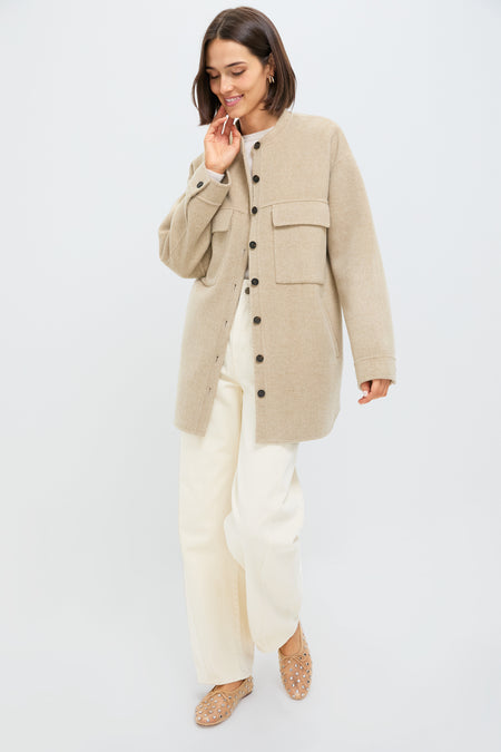 Woman wearing the Beige Chine Florian Coat, a classic, oversized shirt-jacket with chest flap pockets. Paired with cream trousers and tan ballet flats, embodying effortless, high-end style.