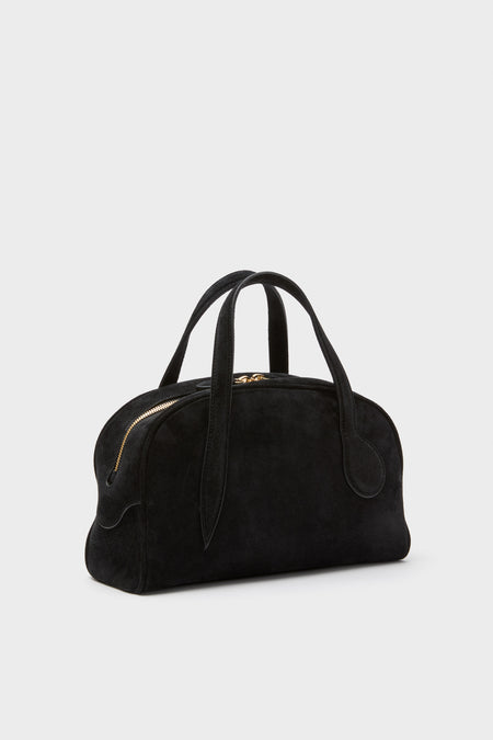 Black Suede Mini Bowling Bag with classic rounded silhouette, effortless sprout handles, and fun gold-tone zipper. High-end Italian craftsmanship with detachable strap for versatile wear.