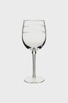 The Juliska clear acrylic wine glass features a long stem and subtle decorative bands around the bowl, making it perfect for outdoor stemware settings.
