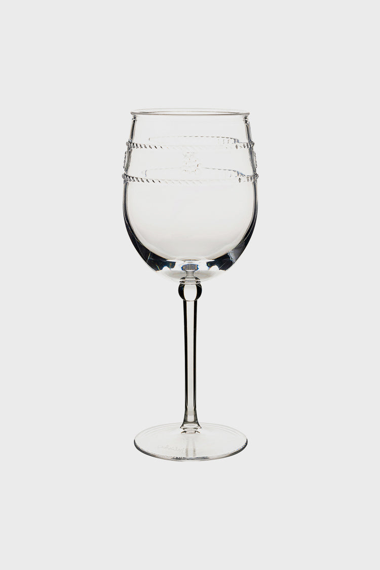 The Juliska clear acrylic wine glass features a long stem and subtle decorative bands around the bowl, making it perfect for outdoor stemware settings.