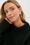 Young woman in a chunky, classic Black Genevieve Cashmere Wool Blend Crewneck Sweater with ribbed finishes, embodying an effortless, high-end, and fun style.