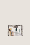 Noir Cypress Toile PVC Wide Large Pouch, clear and classic, filled with an effortless selection of fun, high-end beauty essentials, perfect for stylish travel.