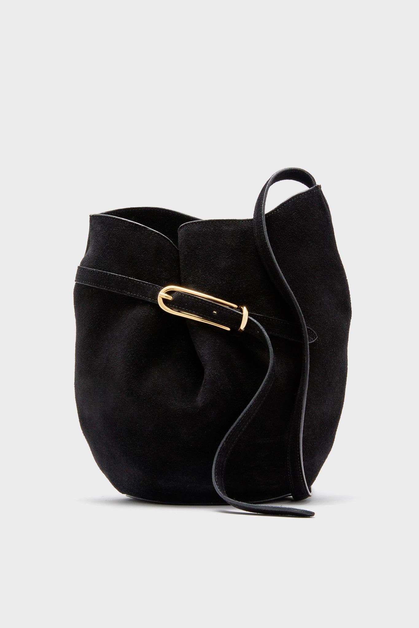 The Liffner Black Suede Belted Bucket Bag features a curved silhouette, Italian craftsmanship, a gold buckle, and a single black strap.