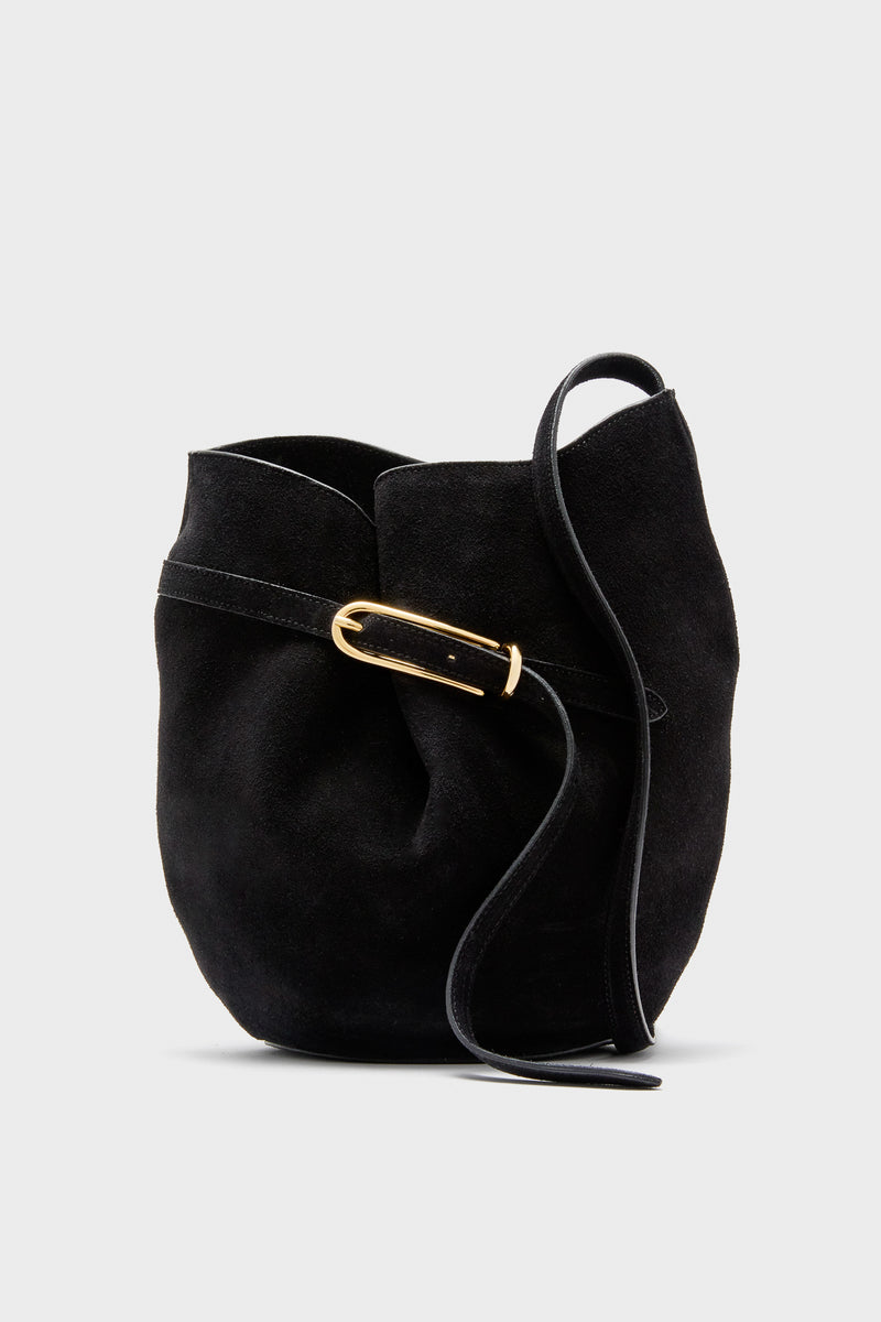 The Liffner Black Suede Belted Bucket Bag features a curved silhouette, Italian craftsmanship, a gold buckle, and a single black strap.