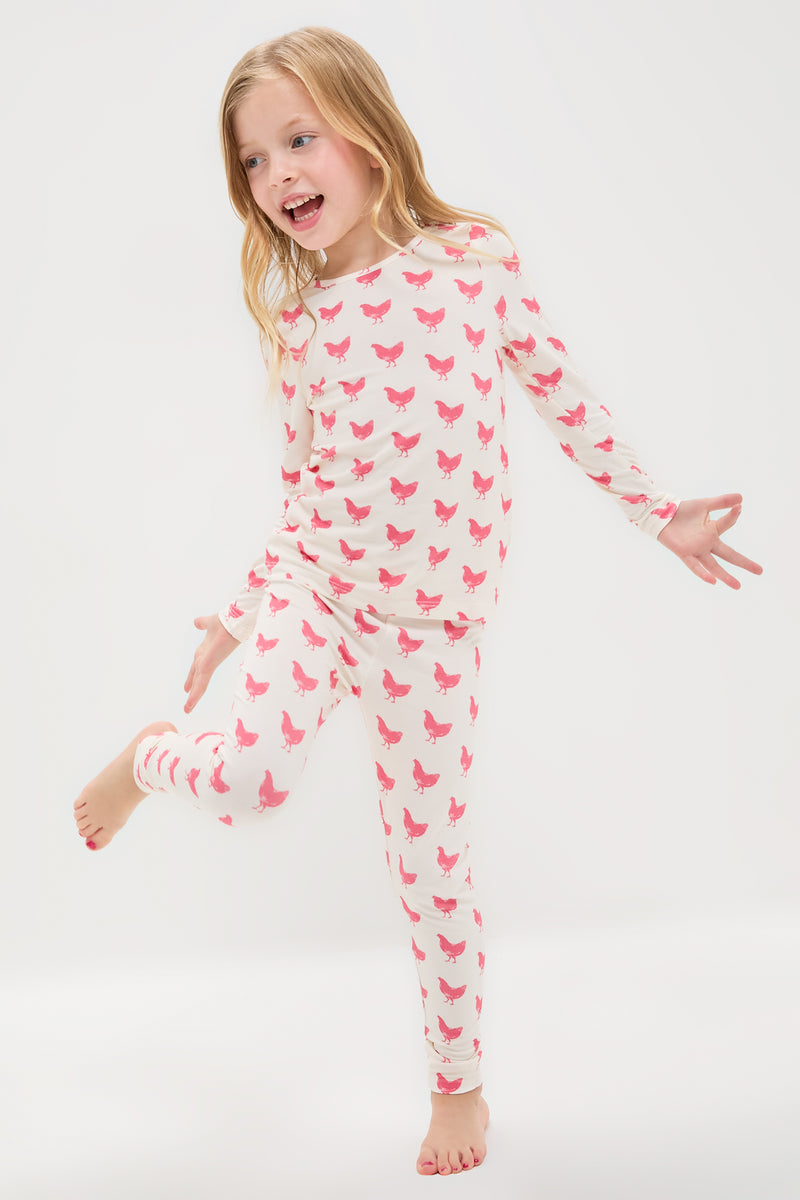 Pink Chickens Kids Bamboo Pj Set features classic, fun hot-pink chicken prints on an off-white bamboo fabric, promising an effortlessly cool and high-end bedtime experience.
