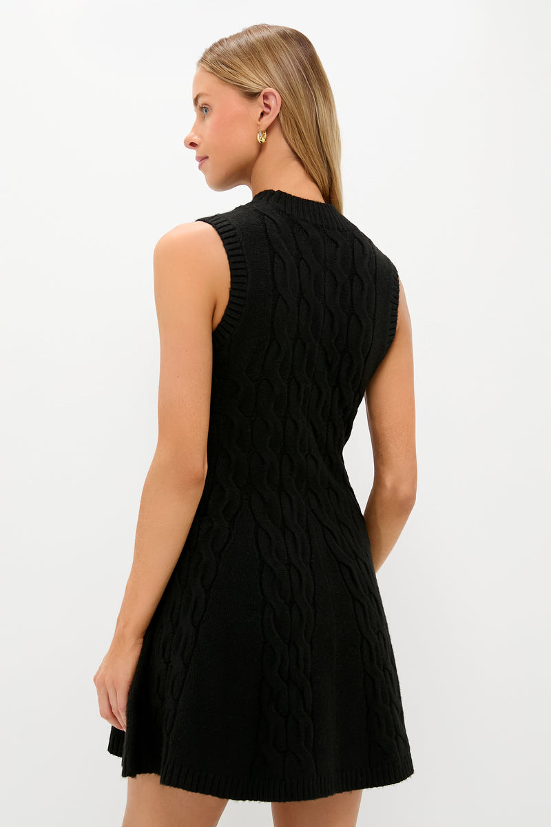 Model wears Black Cable Knit Mini Saxon Dress, featuring a classic fit-and-flare silhouette, sleeveless design, and ribbed finishes, embodying effortless, high-end style.