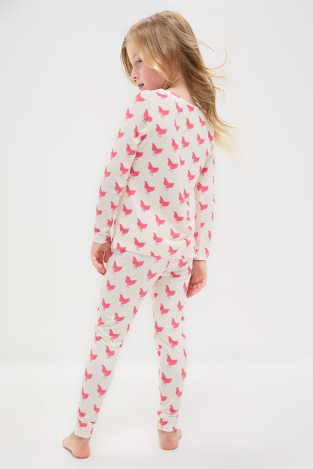 Young girl in Pink Chickens Kids Bamboo Pj Set with chicken print, showcasing a classic, effortless, and fun design; high-end comfort for bedtime routines.