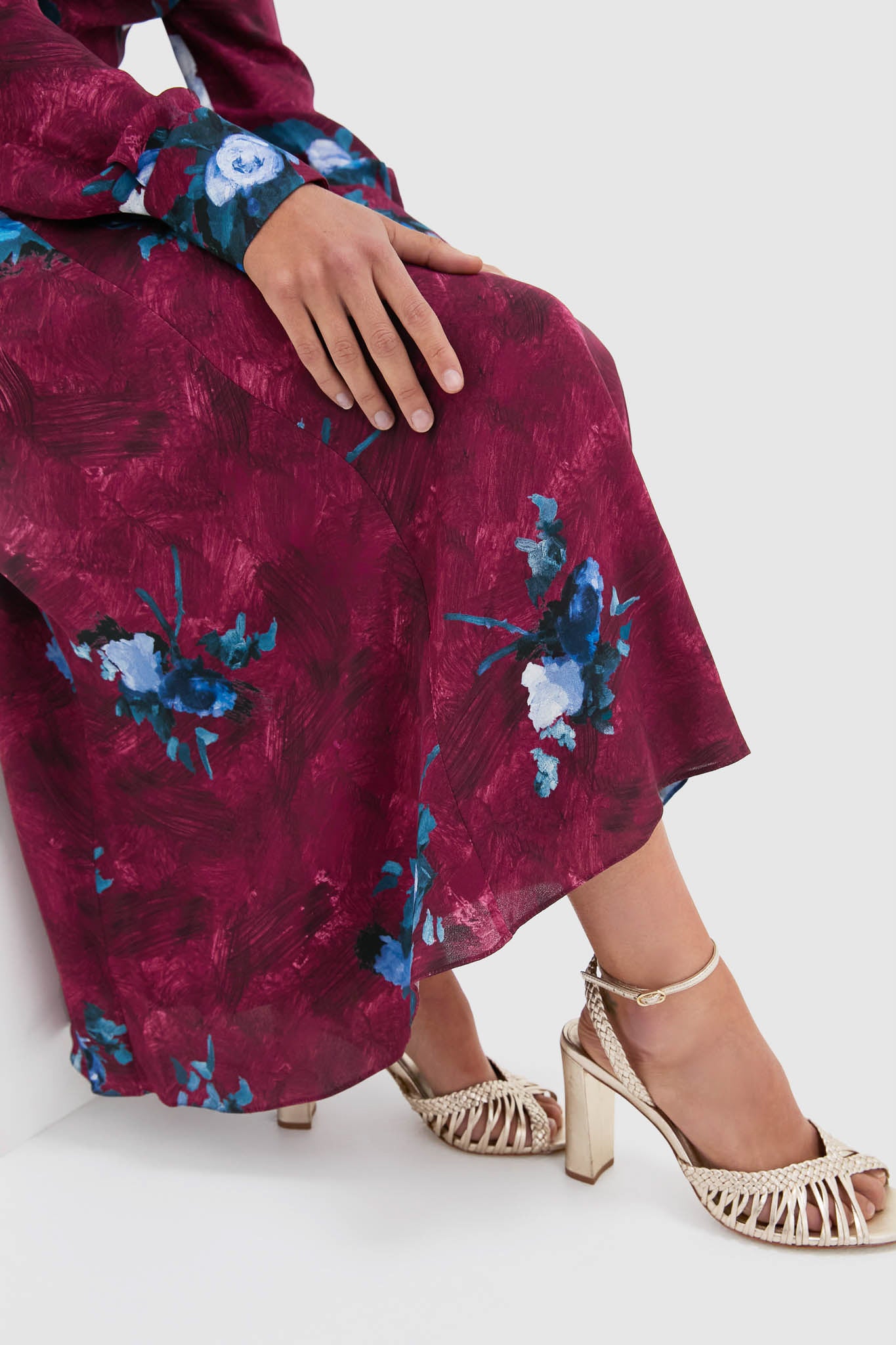 Model wearing the Abstract Rose Milberry Red Long Sleeve Midi Dress, exuding classic elegance with an effortless, high-end feel, paired with fun metallic gold block-heel sandals.