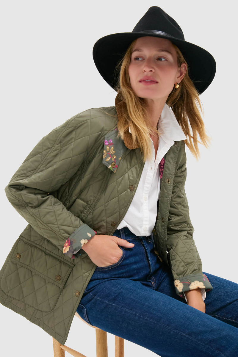 Person wearing an effortless, classic outfit featuring the Black Tack Fedora Hat with leather belt detail, styled with a quilted jacket, jeans, and crisp shirt for a high-end, fun look.