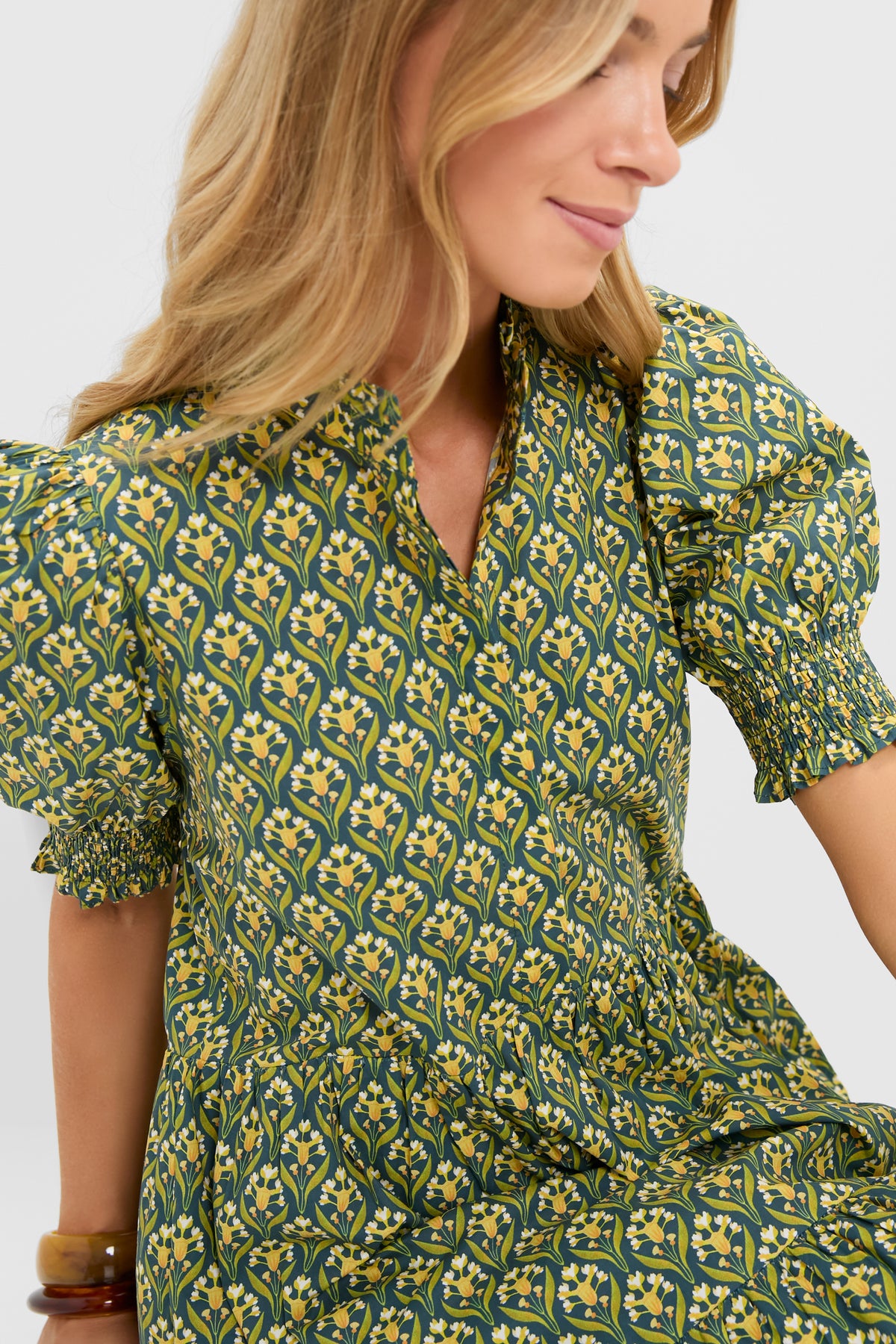 Profile view of a woman in the Forest Green Floral Bennett Maxi Dress featuring classic puffed sleeves, smocked cuffs, and a gathered waist, exuding effortless, high-end elegance.