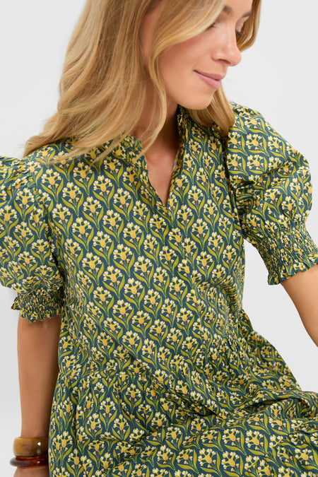 Profile view of a woman in the Forest Green Floral Bennett Maxi Dress featuring classic puffed sleeves, smocked cuffs, and a gathered waist, exuding effortless, high-end elegance.