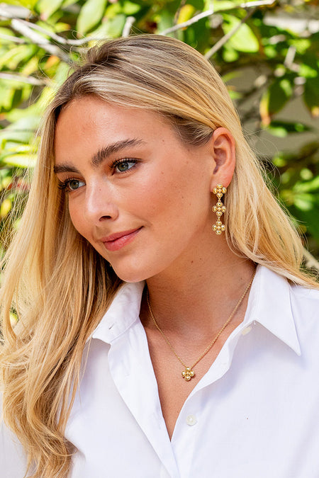 Young woman wears Berry Clover Linear Earrings - Gold, showcasing classic, effortless style with dangling clusters, perfect for a high-end, fun outdoor look.