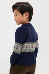 Young boy smiling in a classic, high-end Fairisle Collar Sweater, effortlessly styled with brown corduroy pants, capturing a fun and timeless look.