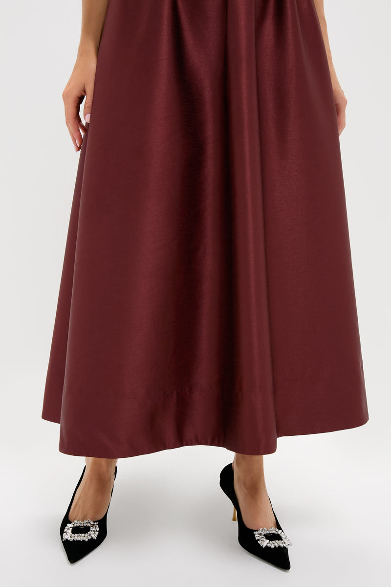Oxblood Dupioni Bow Esme Dress in rich burgundy satin, paired with black pumps featuring rhinestone buckles, embodies classic, effortless elegance for fun, high-end events.