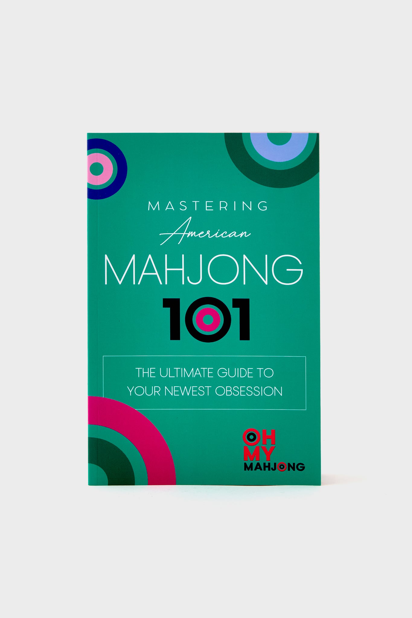 Oh My Mahjong’s "Mastering American Mahjong 101: The Ultimate Mahjong Guide" features a geometric design on a teal cover.