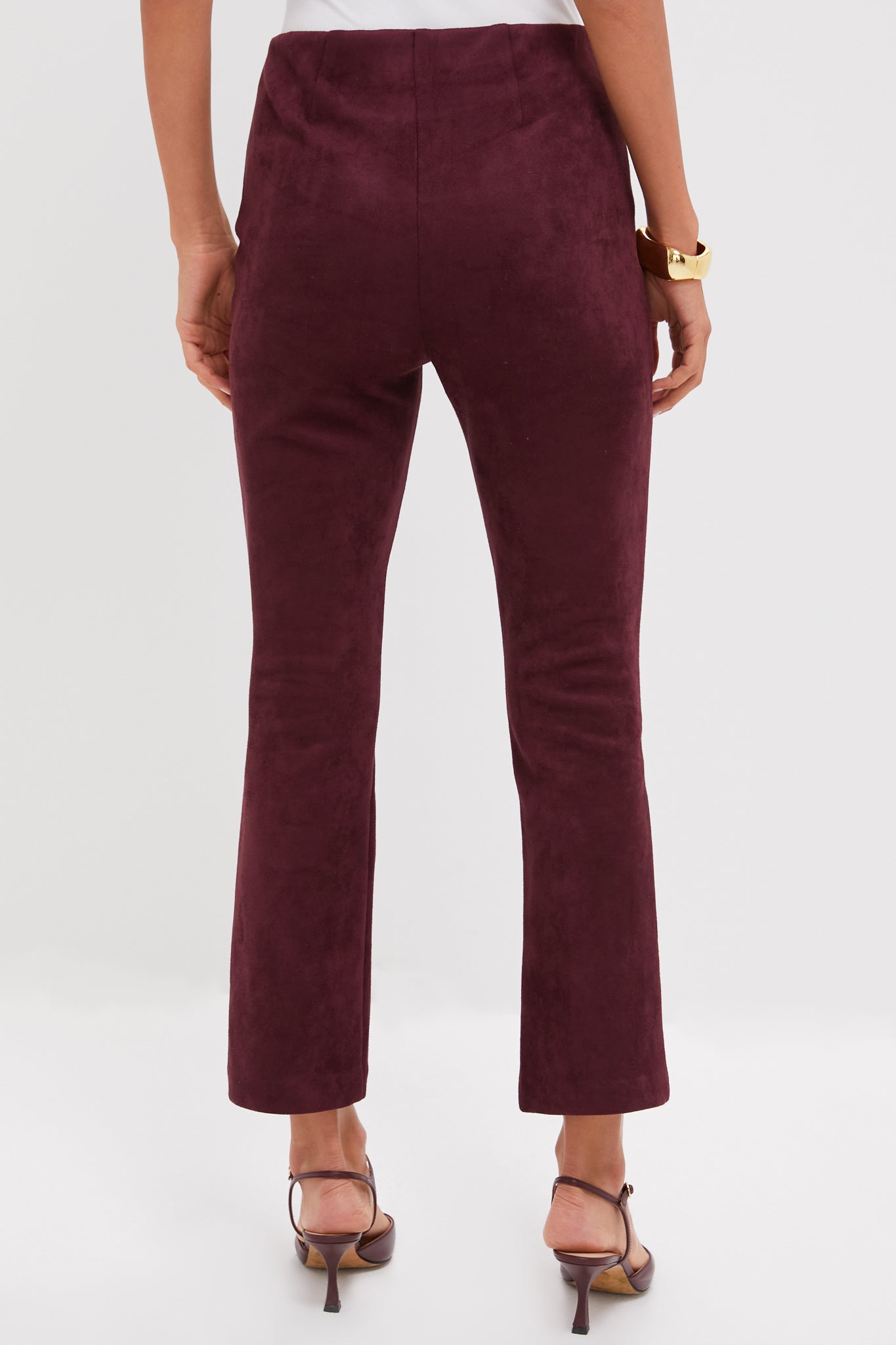 Model wearing Winetasting Vegan Suede Ashford Pants, showcasing a classic, high-end, effortless look with a high rise and cropped kick flare hem, paired with a white top.