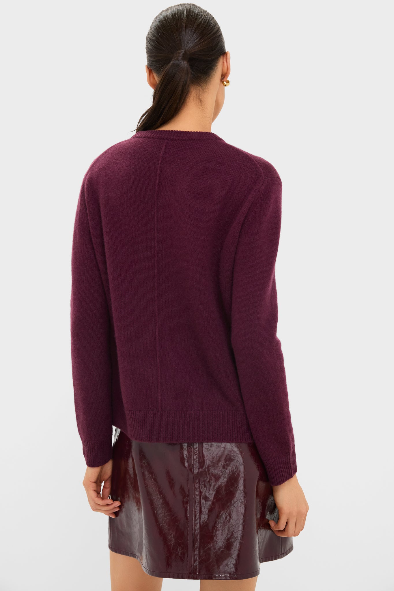 Woman wearing the Winetasting Cashmere Bodie Boyfriend Crewneck, a classic, effortless knit with long sleeves, showcasing high-end style against a light background.