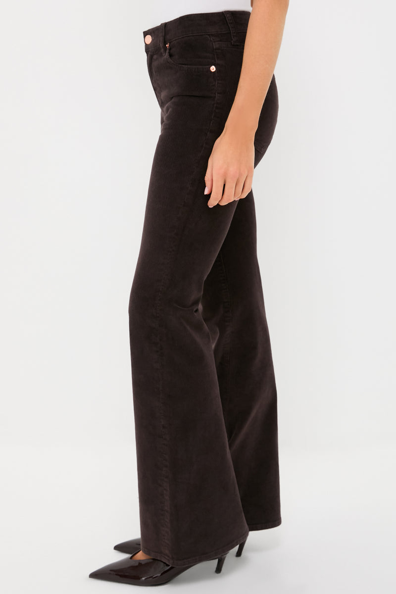 Model in side view wearing Mocha Kinsley Mid Rise Ultra Flare Cord, showcasing classic, effortless style with subtle flare and high-end, fun look, paired with black patent pumps.